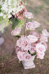 bunches of flowers on the ground, people in the background