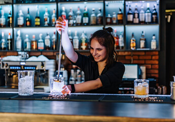 young woman bartender Making Cocktail in bar