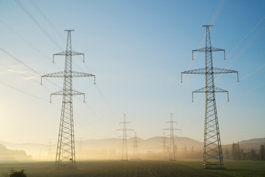 High voltage electricity tower at sunrise.