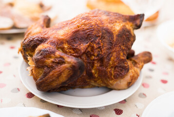 ruddy chicken fried whole on a plate on the festive table