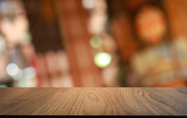 Empty wooden table in front of abstract blurred background of coffee shop . can be used for display or montage your products.Mock up for display of product