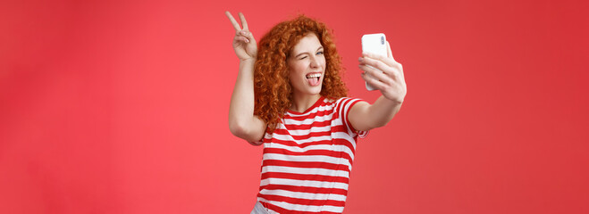 Sassy fashionable playful good-looking redhead daring curly woman show peace victory animal ears...