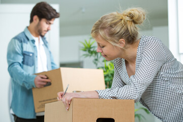 woman writing on parcels