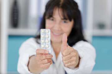 doctor showing pills medicine and thumb up