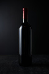 Fototapeta na wymiar bottle of red wine on dark background.
