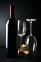 bottle of red wine on dark background.
