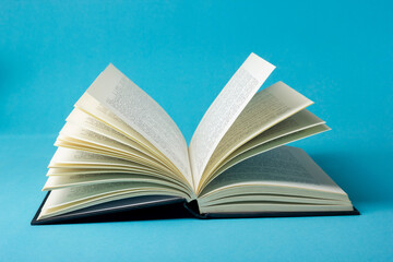 Vintage old hardback books, diary, fanned pages on wooden desk table and grunge background Daylight. Books stacking. Back to school. Copy Space. Education background