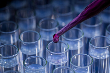 Pipette dropping fluid into test tube