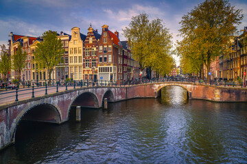 Fototapeta na wymiar Spectacular old bridges over the water canals in Amsterdam, Netherlands