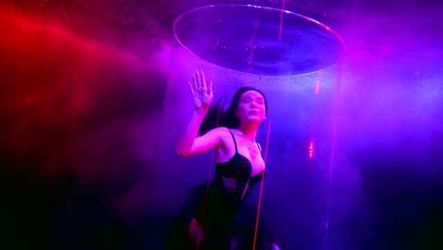 slender busty asian woman swimming underwater, fashion model in glass tube inside pool