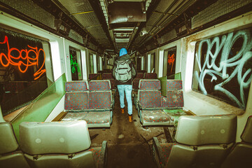 Man exploring an old derailed train with graffitis that crashed in a undergound tunnel 