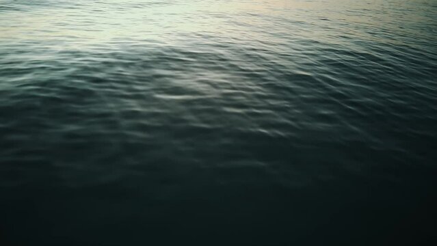 Aerial View Of Blue Ocean Waves From Above. Sea Waves From An Aerial Drone Shot. Bird's Eye View Of Ocean Waves.