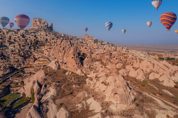 Color hot air balloons fly background ancient Uchisar castle, Cappadocia Turkey landscape. Aerial top view Goreme national park