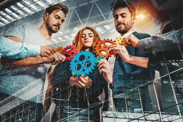 Teamwork of businesspeople work together and combine pieces of gears as partnership and integration