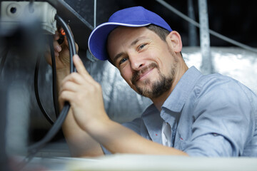 happy craftsman working with cables