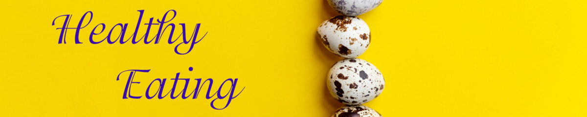 fresh Spotted Quail eggs in a row.Organic eggs on yellow table. Healthy food concept. web banner.Top view, copy space. Selective focus. text healthy eating