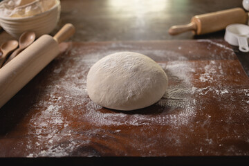 Top view of Wooden table mess up in white flour after make bread