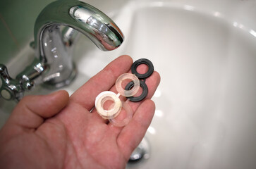 Replacement of rubber gaskets in the faucet. Plumbing work in the bathroom. Call the master plumber...