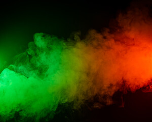 Red yellow green smoke on a black background.