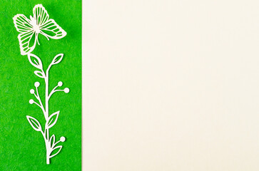 Obraz premium A Butterfly and flower made from carve paper or cutting on green and yellow background with empty space for your text or message.