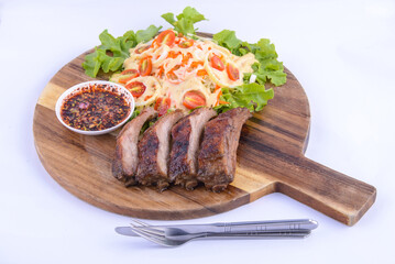 Roasted pork steak on the wooden plate with thai sauce.