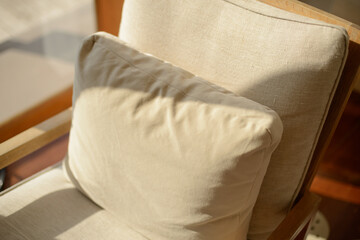 Cozy style. Beige cushions decorate the house on the sofa at afternoon.