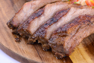 Roasted pork steak on the wooden plate with thai sauce.