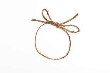 String twine rope bow isolated on white, jute string closed loop, natural fiber brown thread