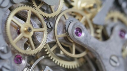 Vintage clock mechanism gear motion, macro close-up