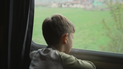Little boy watching on train window during travelling in vacation
