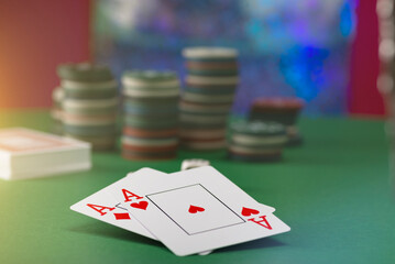 Two aces and stack of Casino Chips in background