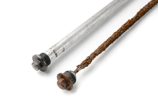 Worn and new magnesium anode to protect an electric water heater from rust on a white isolated fonn, close-up.