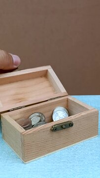 Hand open treasure chest. put coins in the chest