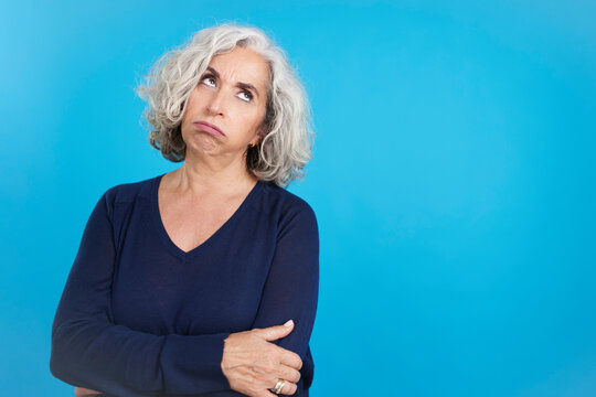 Mature woman looking up with expression of boredom