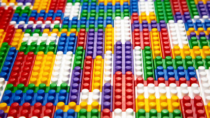 Abstract background texture of colored constructor blocks. Background of colorful plastic part of constructor. Pile of colored toy bricks.