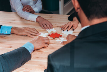 Business team connect pieces of puzzle like a teamwork and partners