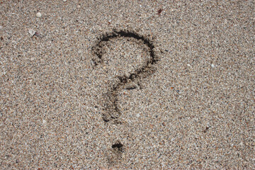 Fototapeta na wymiar question mark on beach sand