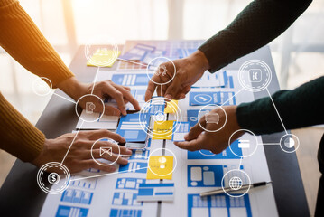  UX developer and ui designer brainstorming about mobile app interface wireframe design with customer breif and color code at modern office.