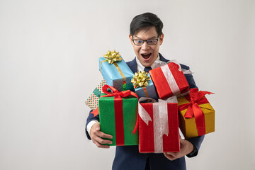 Portrait of confident Asian businessman in glasses carrying gift box isolated on white background