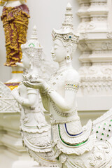 Fototapeta premium Thai white angel statue with lotus in temple