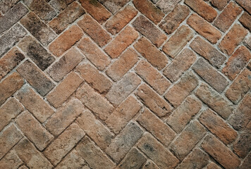Top view of old bricks paving stones footpath pattern on sidewalk outdoors as brickwork weave...