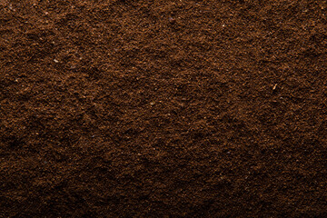 Cup of coffe and brown coffee surface texture background.