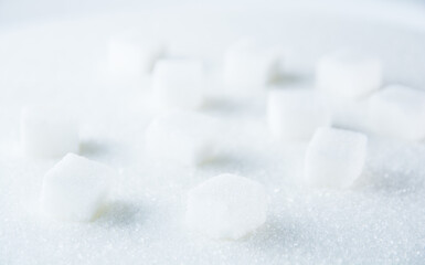 Fototapeta na wymiar A stack of sugar cubes on a sugary surface. 
