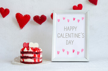 Happy Galentine`s day greeting card. Red felt hearts with stitches, sweet cake and frame on the white background.  Watercolor hearts and text on paper blank.
