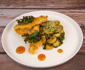 Recipe for Breaded Chicken Tenders and Potatoes with Sesame Kale Chips and Sweet and Sour Sauce. High quality photo