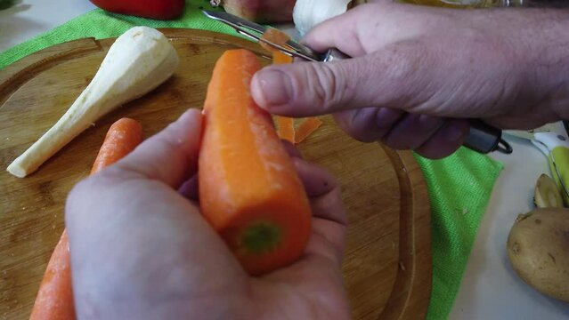 Piling carrot pov close up follow shot. Healthy food preparation. Raw vegetables. High quality 4k footage