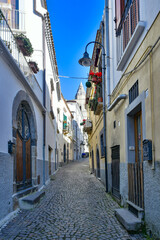 Fototapeta na wymiar A narrow street among the old houses of Melfi, a village in the province of Potenza in Italy.
