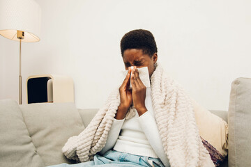 a black woman blowing their nose