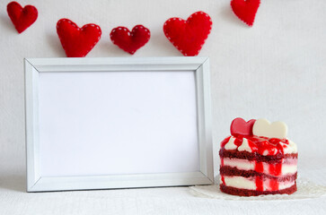 Mock up greeting card. Red felt hearts with stitches, sweet cake and frame on the white background,...