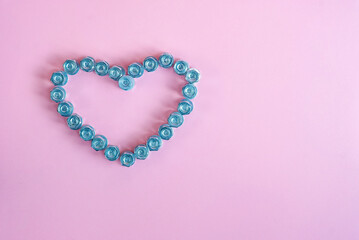 Bright pink background with a heart of bolts and nuts. The concept of the Valentine's Day holiday. Beautiful background and free space for text.